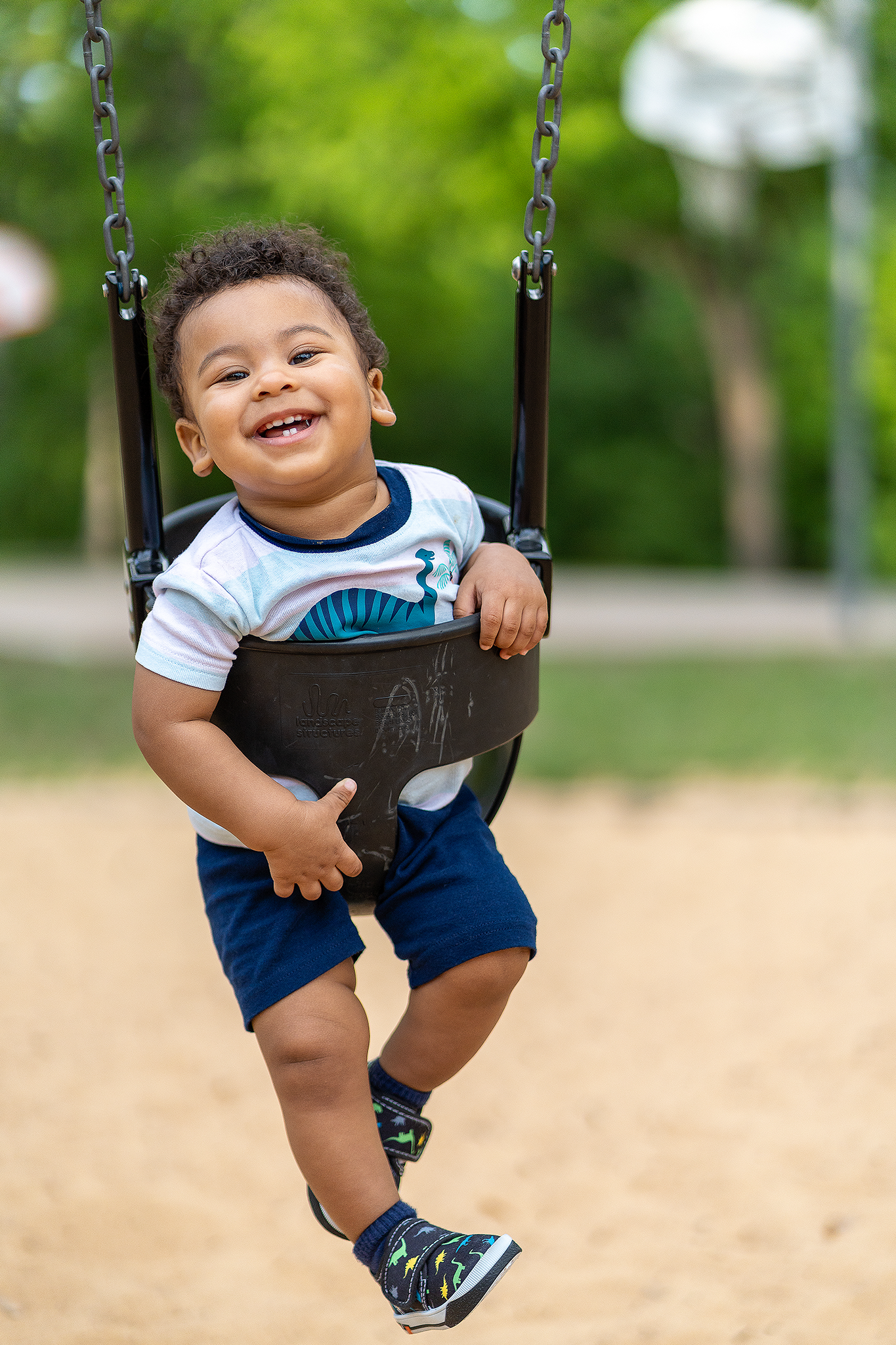 Child on a swing, mid-laughter